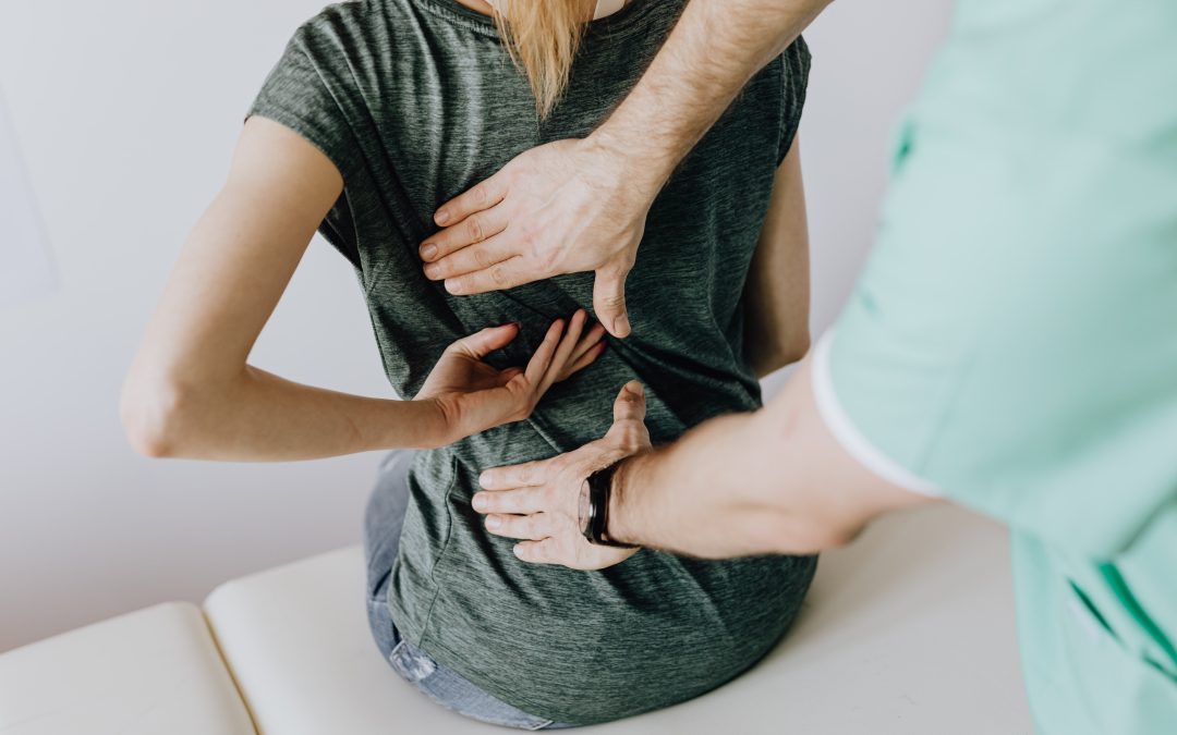 Chiropractor looking at back